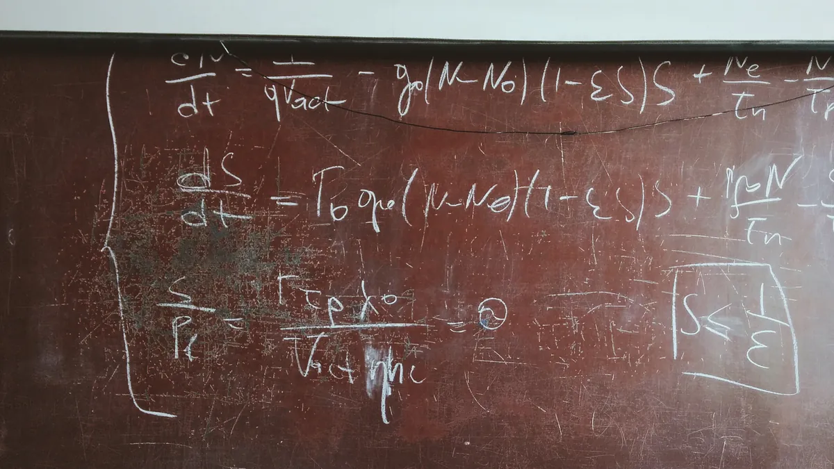 Chalkboard covered in handwritten differential equations, with an inequality boxed in the lower right corner