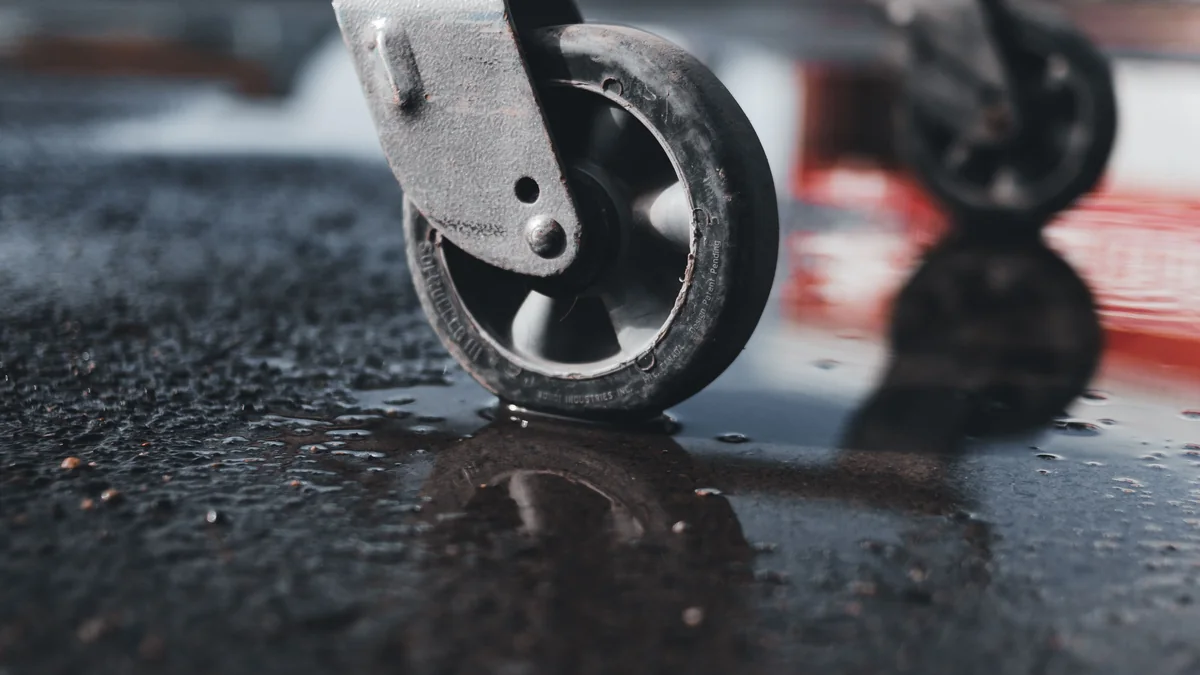 Close-up of a small shopping-trolley castor wheel on wet tarmac