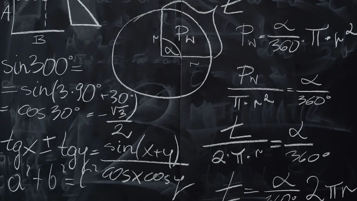 Chalkboard covered in handwritten trigonometry working, step-by-step derivations and a circle-sector diagram