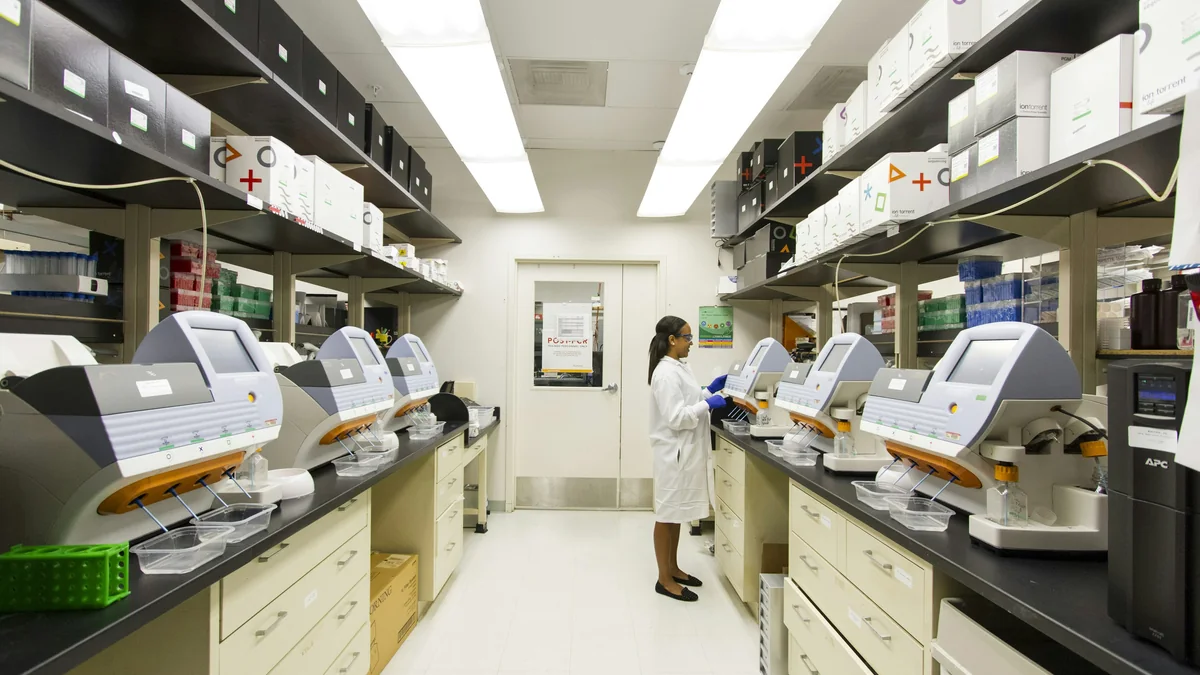 A technician working among genome sequencing machines in the National Cancer Institute's Cancer Genomics Research Laboratory